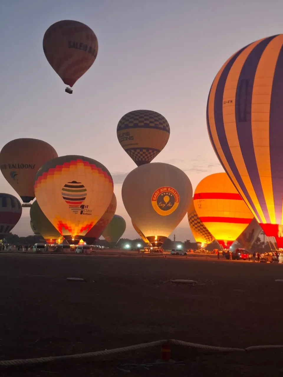 Balloons glowing before a sunrise flight in Luxor